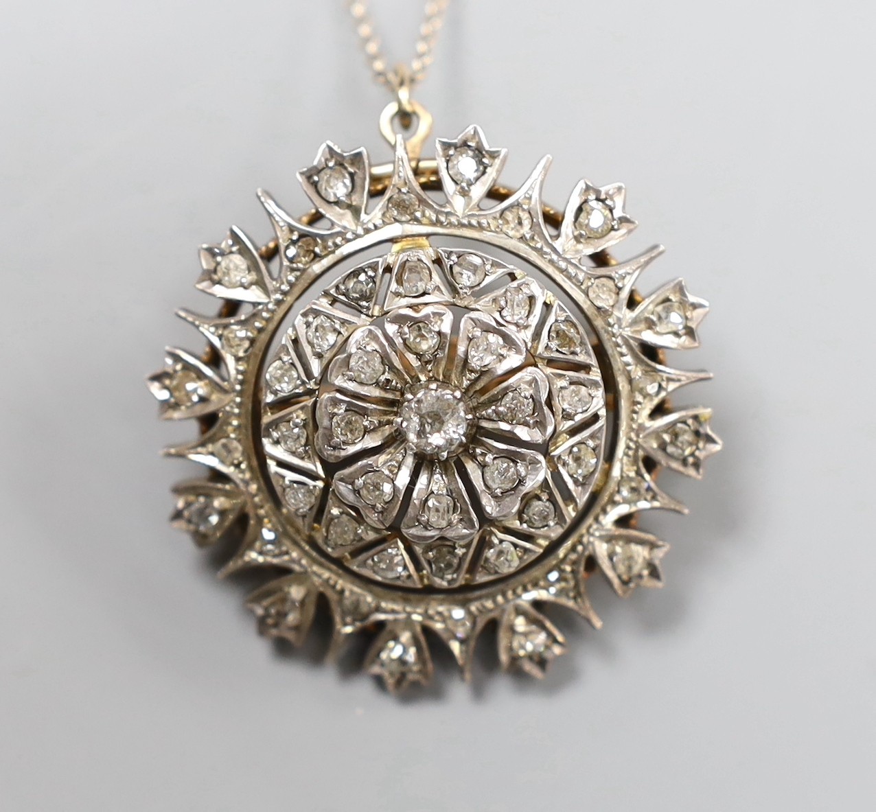 A late Victorian gold silver and diamond circular cluster pendant brooch, 3.5cm, gross 17.5 grams